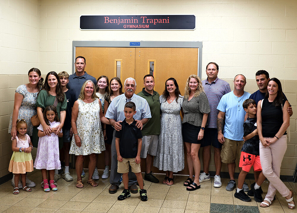 Last week the Marlboro Elementary School gymnasium was named in honor of retired physical education teacher Benjamin Trapani. He and his wife Susan are surrounded by family.